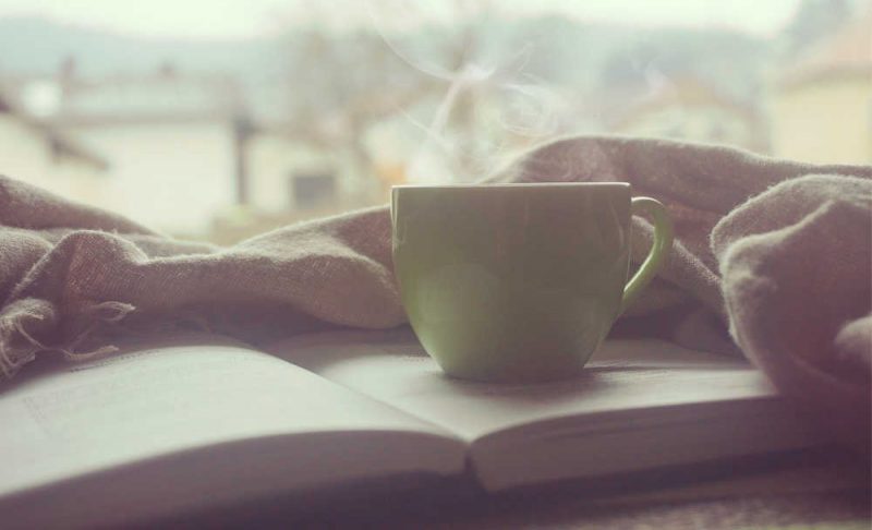 a cup of coffee and a book