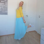 light blue maxi skirt, yellow v-neck sweater, white trainers